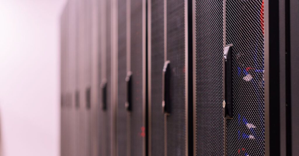 Row of similar lockers with various optic fiber cables in modern data server room